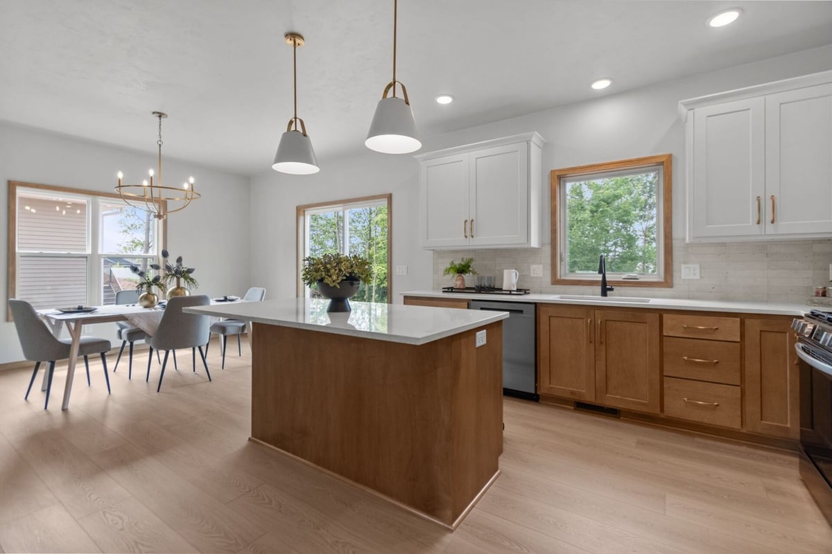 Kitchen with quartz island and pendant lighting in an Ellington, WI custom home by Midwest Design Homes