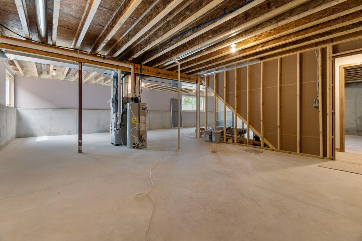 Open basement space under construction in a custom home in Appleton, WI by Midwest Design Homes