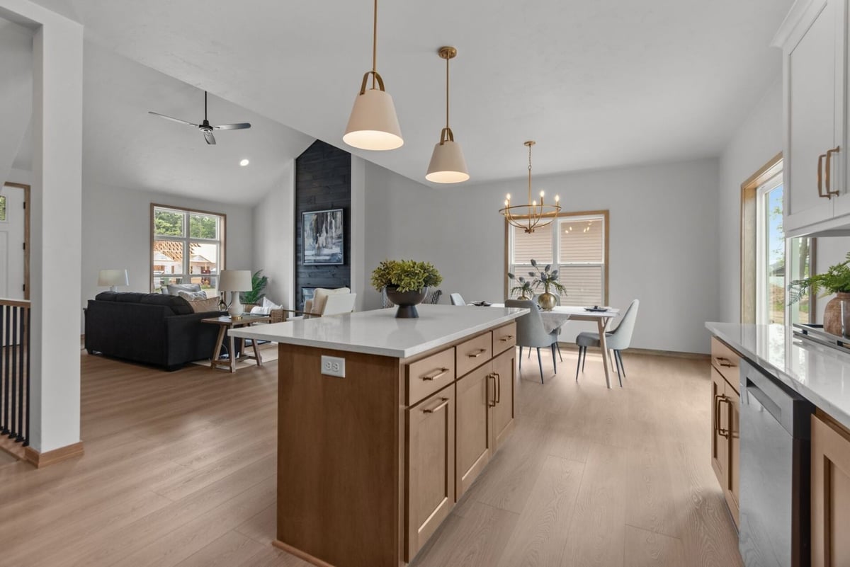Open-concept kitchen island with view of dining and living spaces in a Greenville, WI home