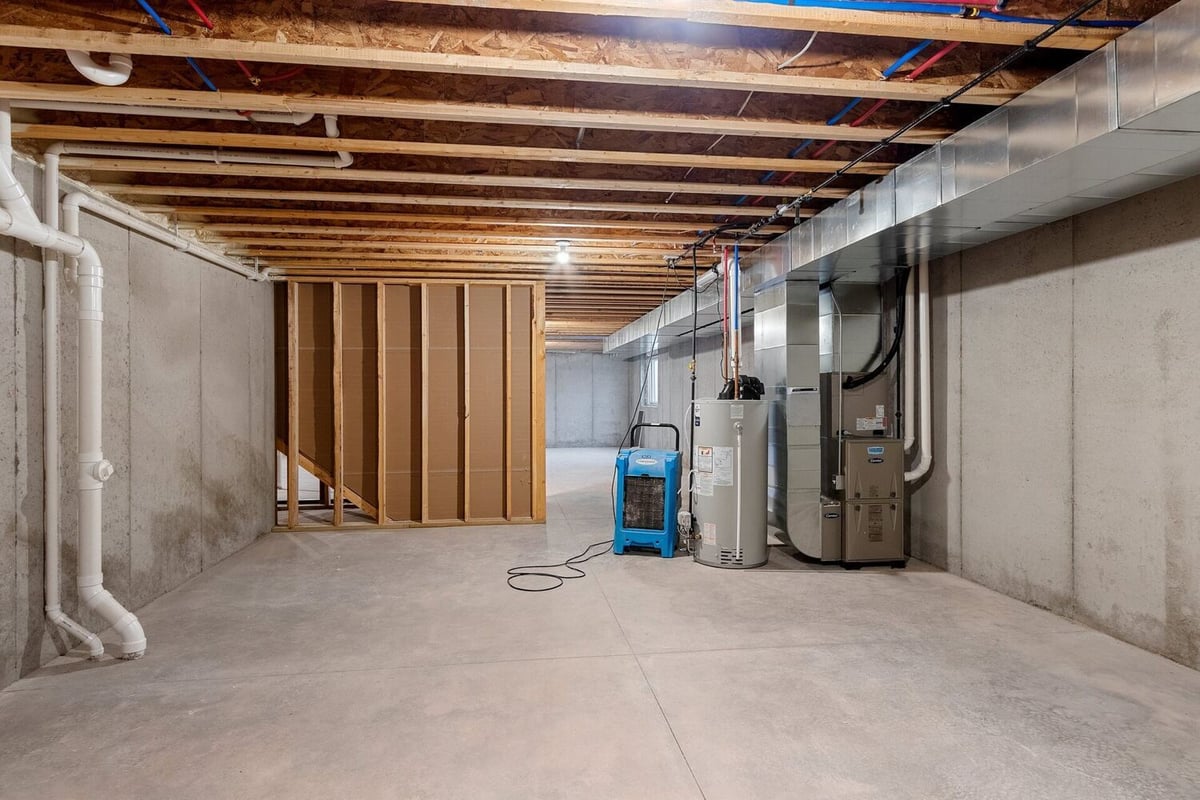 Basement with HVAC and plumbing systems in a Midwest Design Homes custom home in Kaukauna, WI