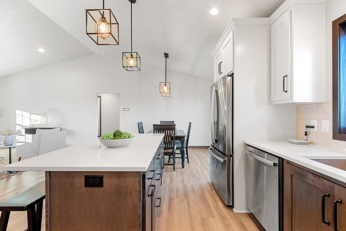 Kitchen island with pendant lights in a Midwest Design Homes custom home in Kaukauna, WI