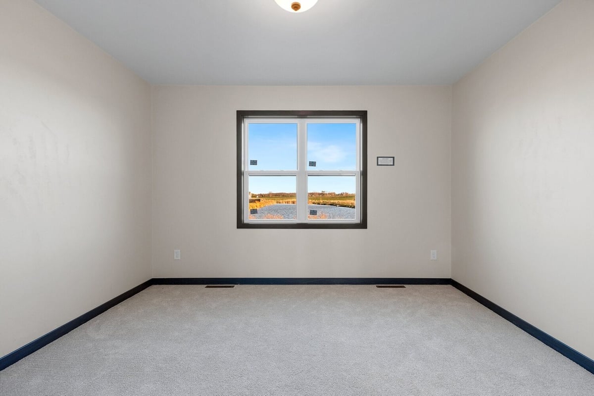 Spacious bedroom with carpet flooring in a Midwest Design Homes custom home in Kaukauna, WI