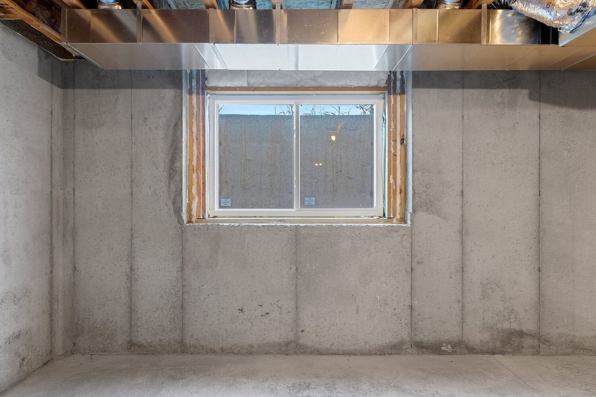 Unfinished basement with egress window in a Midwest Design Homes custom home in Kaukauna, WI
