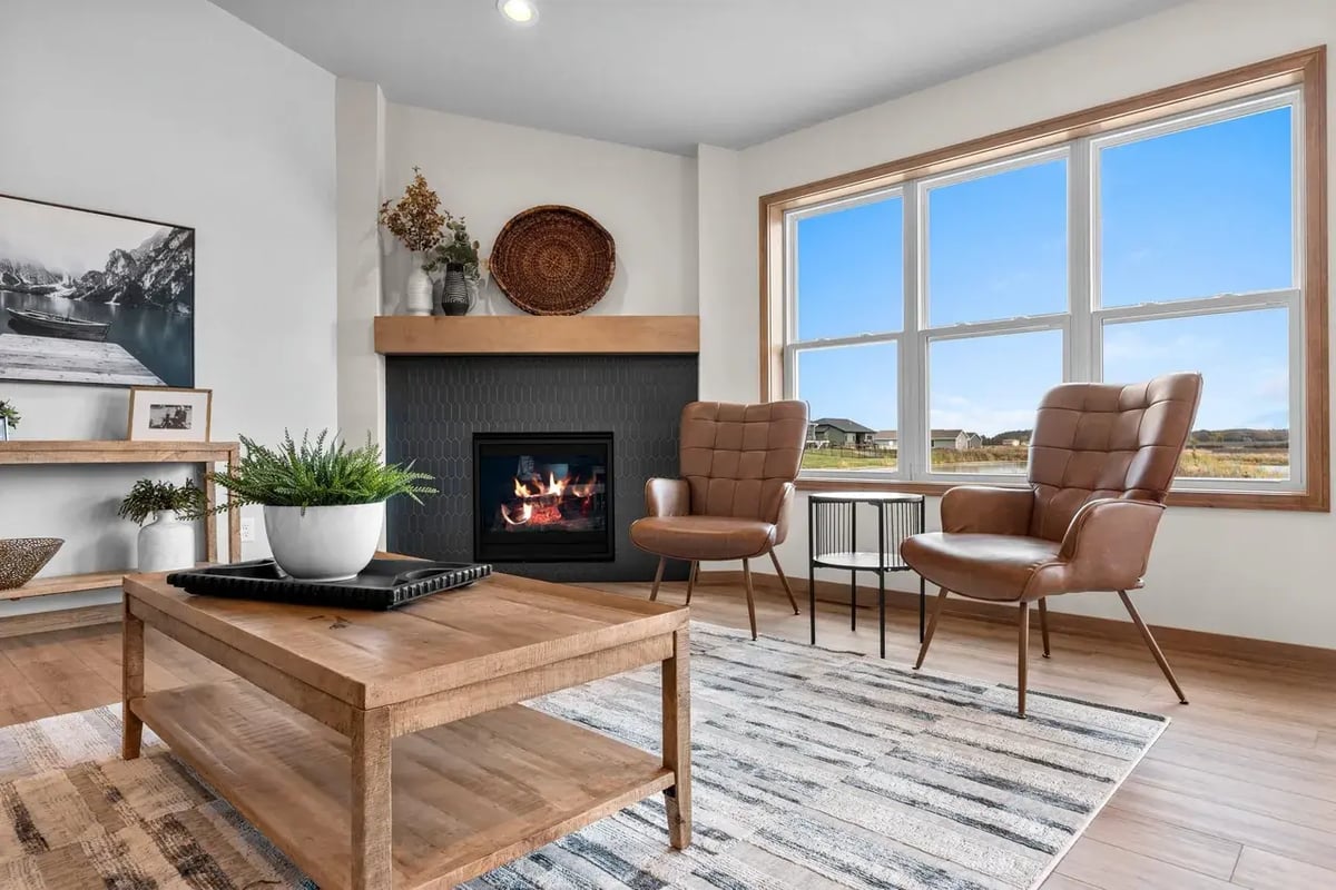 Cozy living room with fireplace, large windows, and modern décor in a Fox Cities home