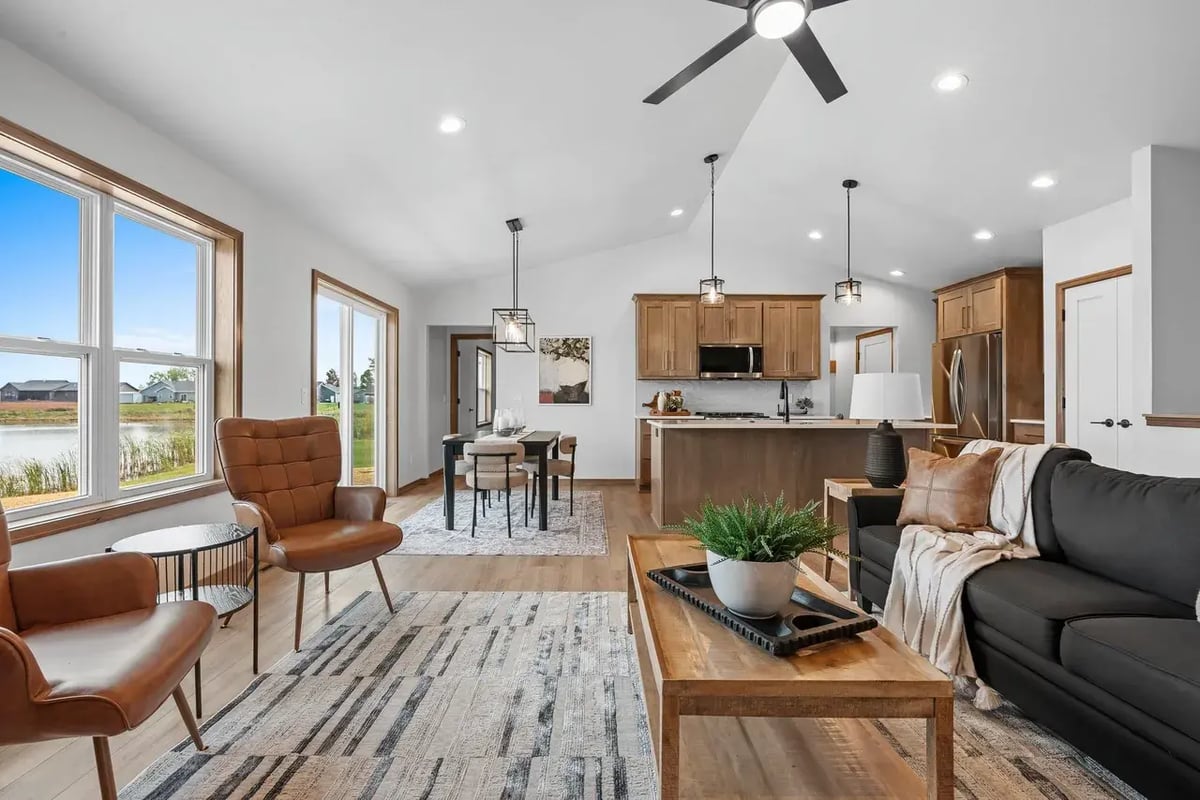 Open-concept Fox Cities living area with lake views, modern kitchen, dining space, and cozy seating with natural light