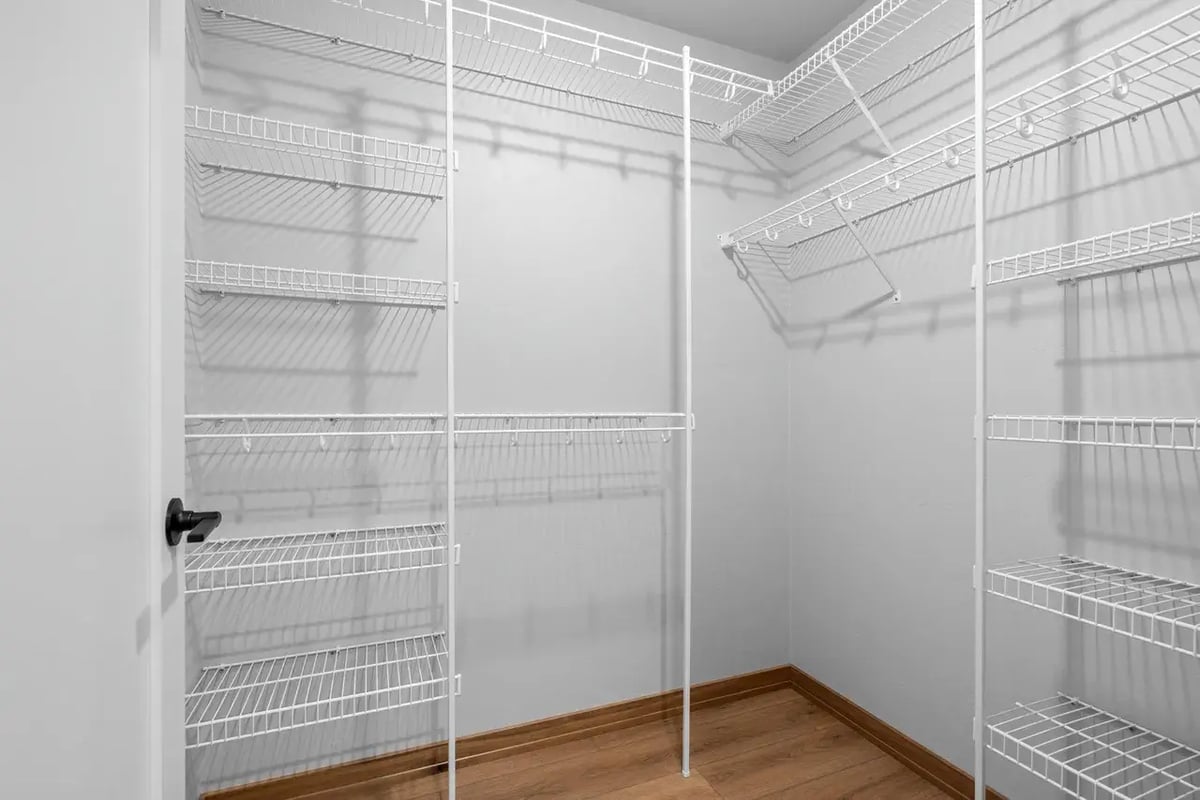 Spacious Fox Cities pantry with white wire shelving, wood-look flooring, and ample storage space for kitchen organization