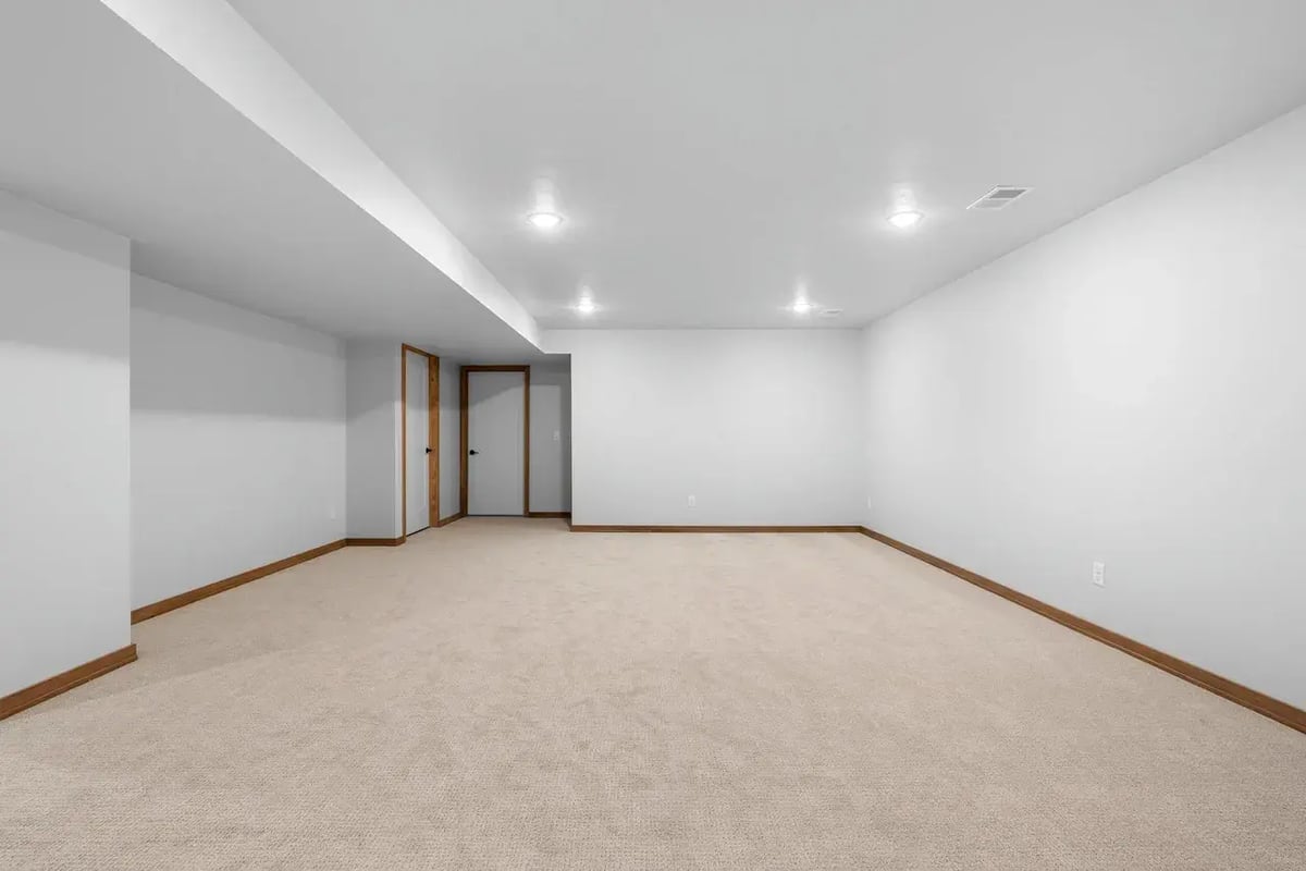 Spacious finished basement in the Fox Cities with neutral carpet, recessed lighting, and white walls