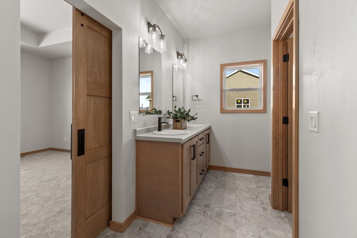 Bathroom vanity with dual sinks and mirrors by Midwest Design Homes in Kaukauna, WI