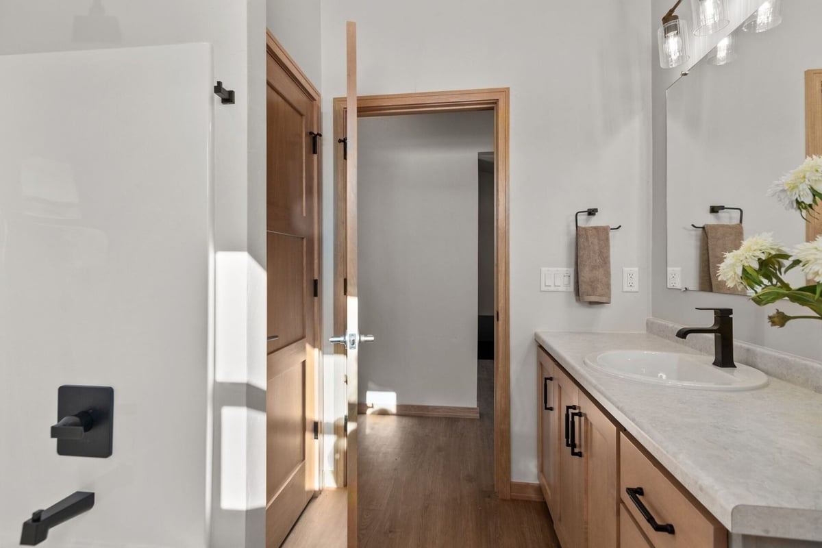 Bathroom with double vanity and wood cabinetry in a Midwest Design Homes custom build in Appleton, WI