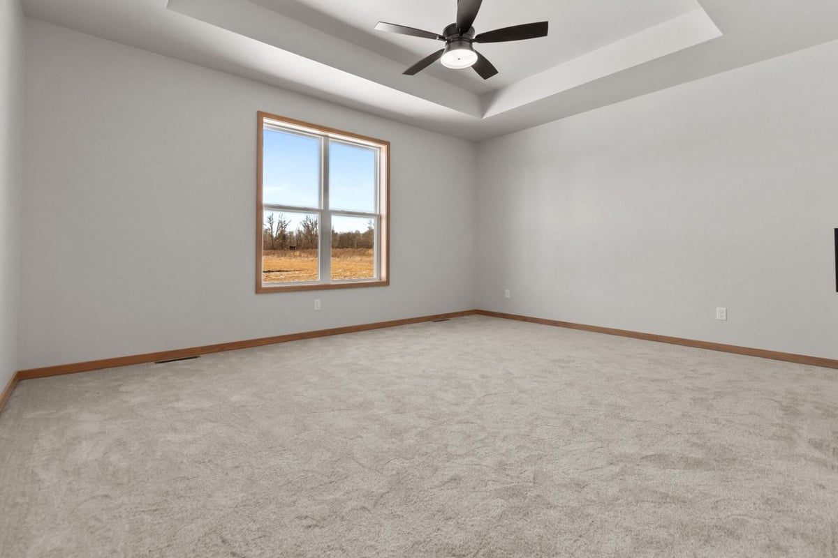 Bright master bedroom with ceiling fan by Midwest Design Homes in Greenville, WI