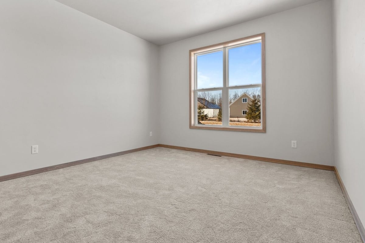 Bright natural light fills this bedroom in a Midwest Design Homes custom home in Greenville, WI