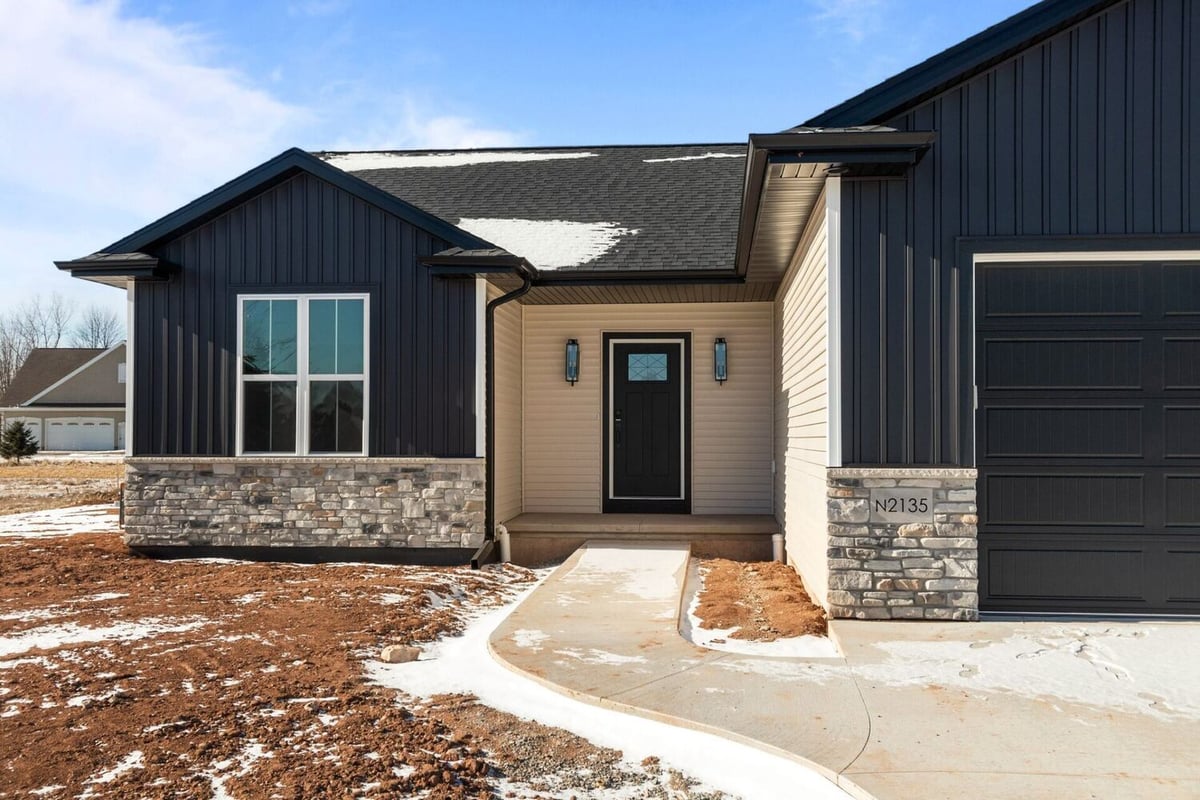 Custom ranch-style home exterior with stone accents by Midwest Design Homes in Kaukauna, WI