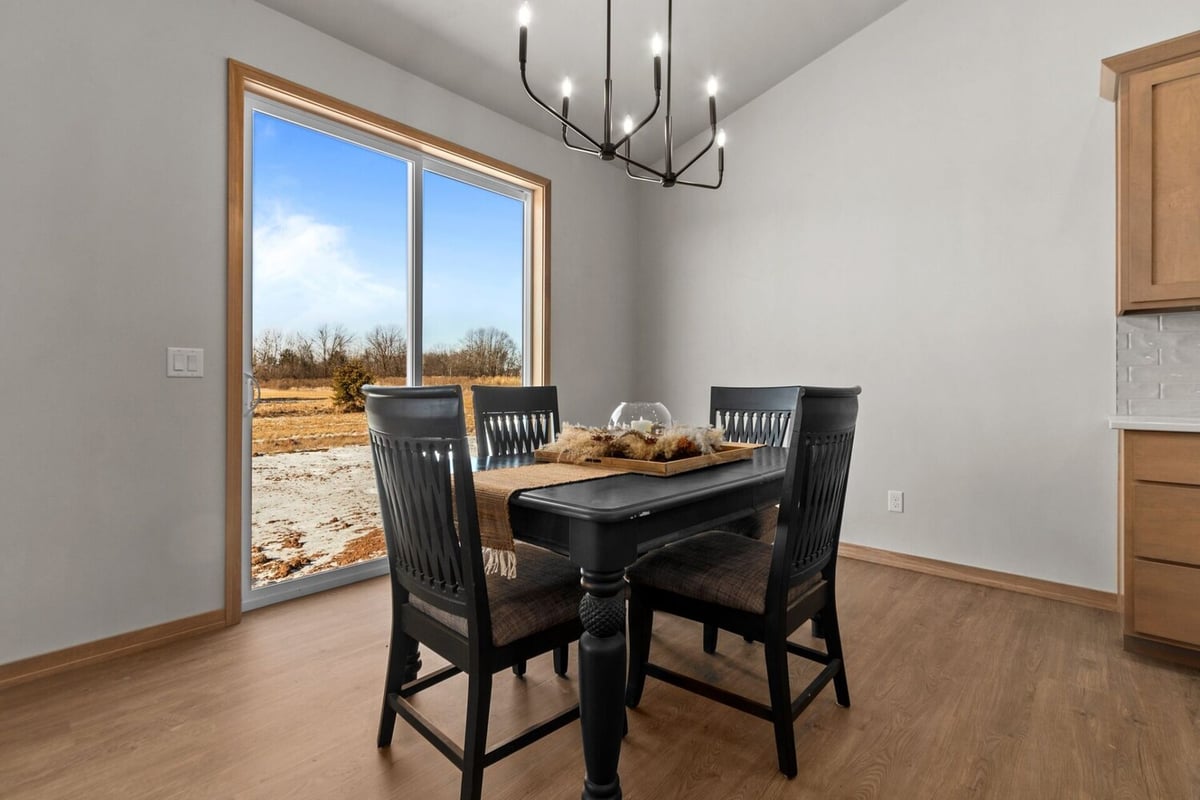 Dining room with modern chandelier in a Midwest Design Homes custom home in Fremont, WI