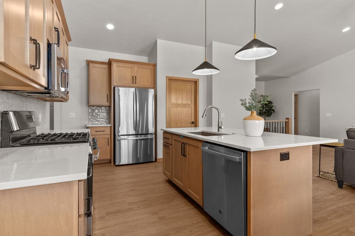 Kitchen island with sink in a Midwest Design Homes custom home in De Pere, WI