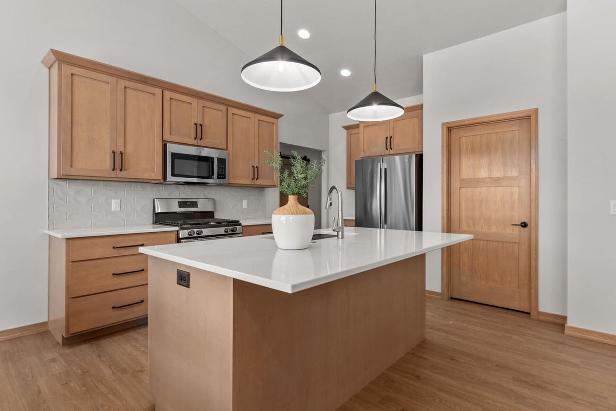 Kitchen with island and pendant lighting by Midwest Design Homes in Kaukauna, WI