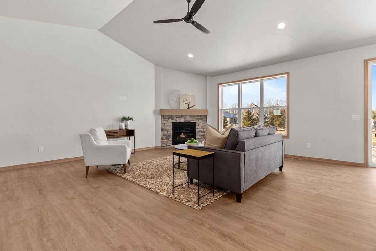 Living room with fireplace and modern furnishings by Midwest Design Homes in Kaukauna, WI