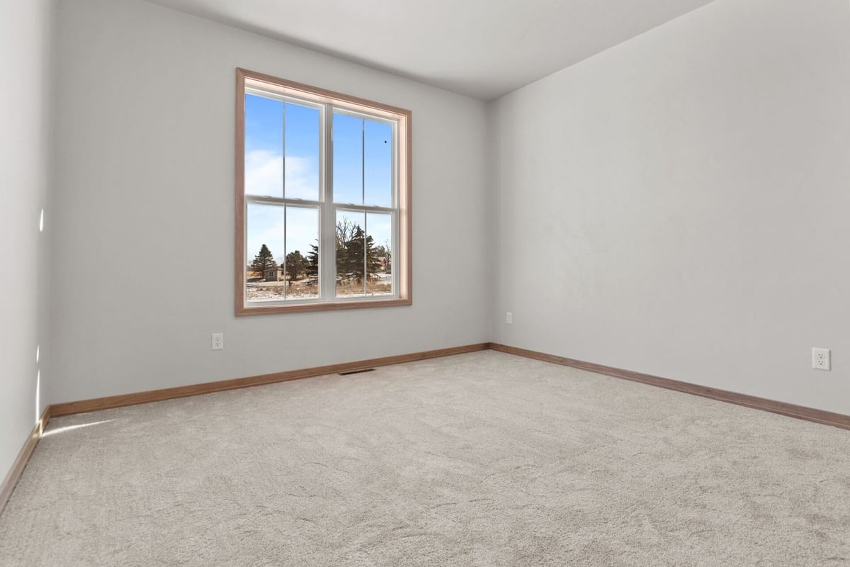 Neutral-toned custom home bedroom designed by Midwest Design Homes in the Fox Cities, WI