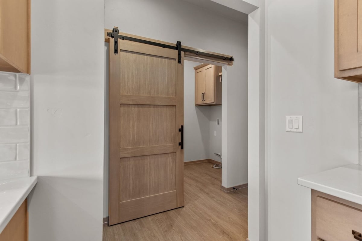 Sliding barn door in laundry room of a Midwest Design Homes custom home in Neenah, WI