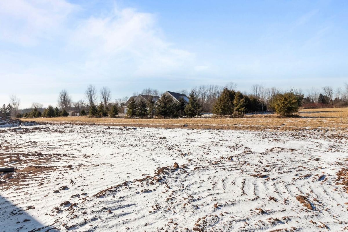 Snow-covered lot surrounding a custom home by Midwest Design Homes in De Pere, WI
