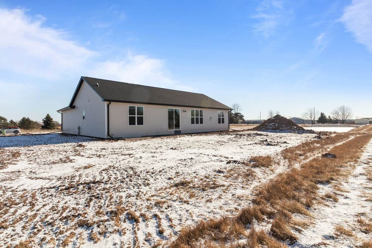 Snow-dusted backyard of a new custom home built by Midwest Design Homes in Lawrence, WI