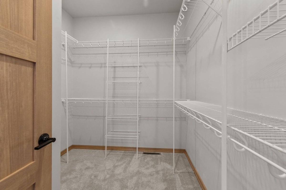 Spacious walk-in closet with shelving in a Midwest Design Homes custom home in De Pere, WI