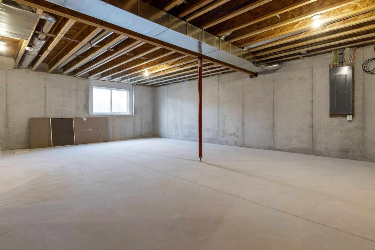 Unfinished basement with concrete floors in a Midwest Design Homes custom home in Fremont, WI