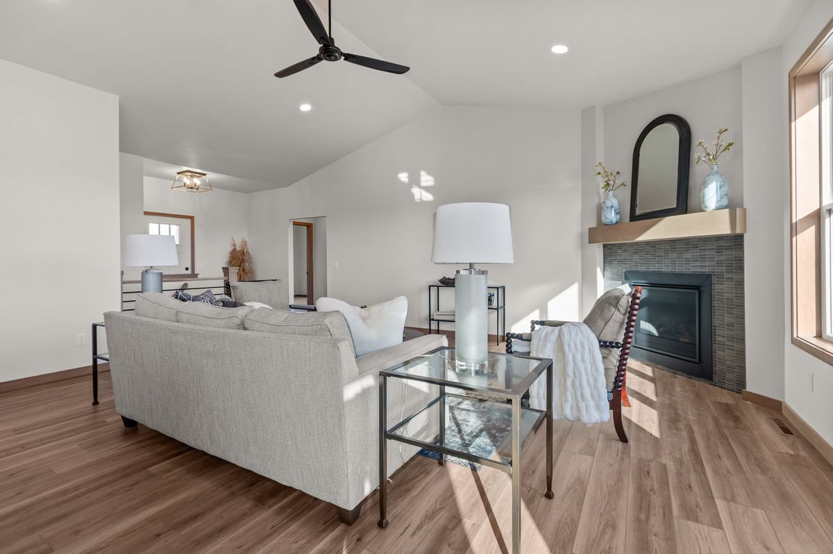 Bright great room with seating, fireplace, and vaulted ceiling, located in the Fox Cities