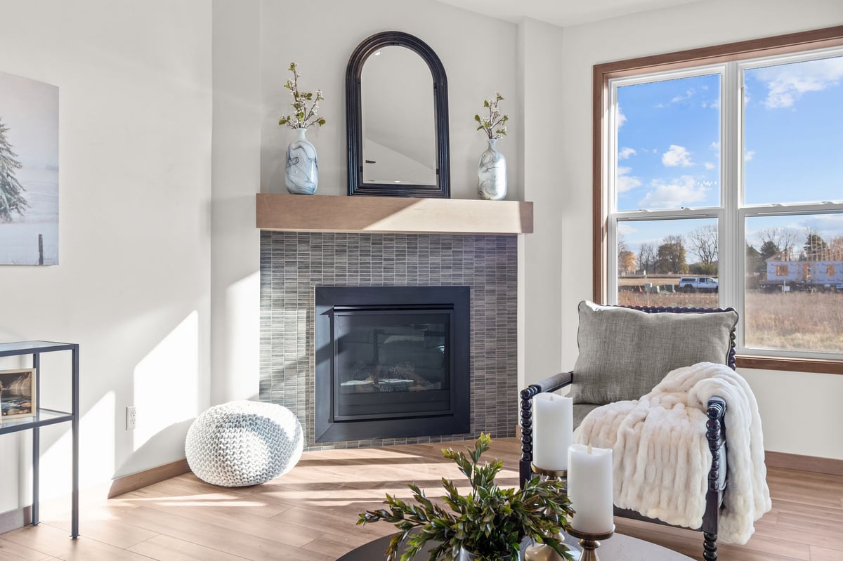 Cozy living room fireplace with tile surround, mantel decor, and seating area, located in the Fox Cities