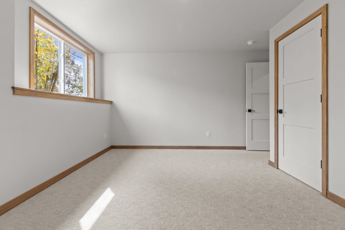 Basement room with built-in nook and daylight window by Midwest Design Homes in Lawrence, WI