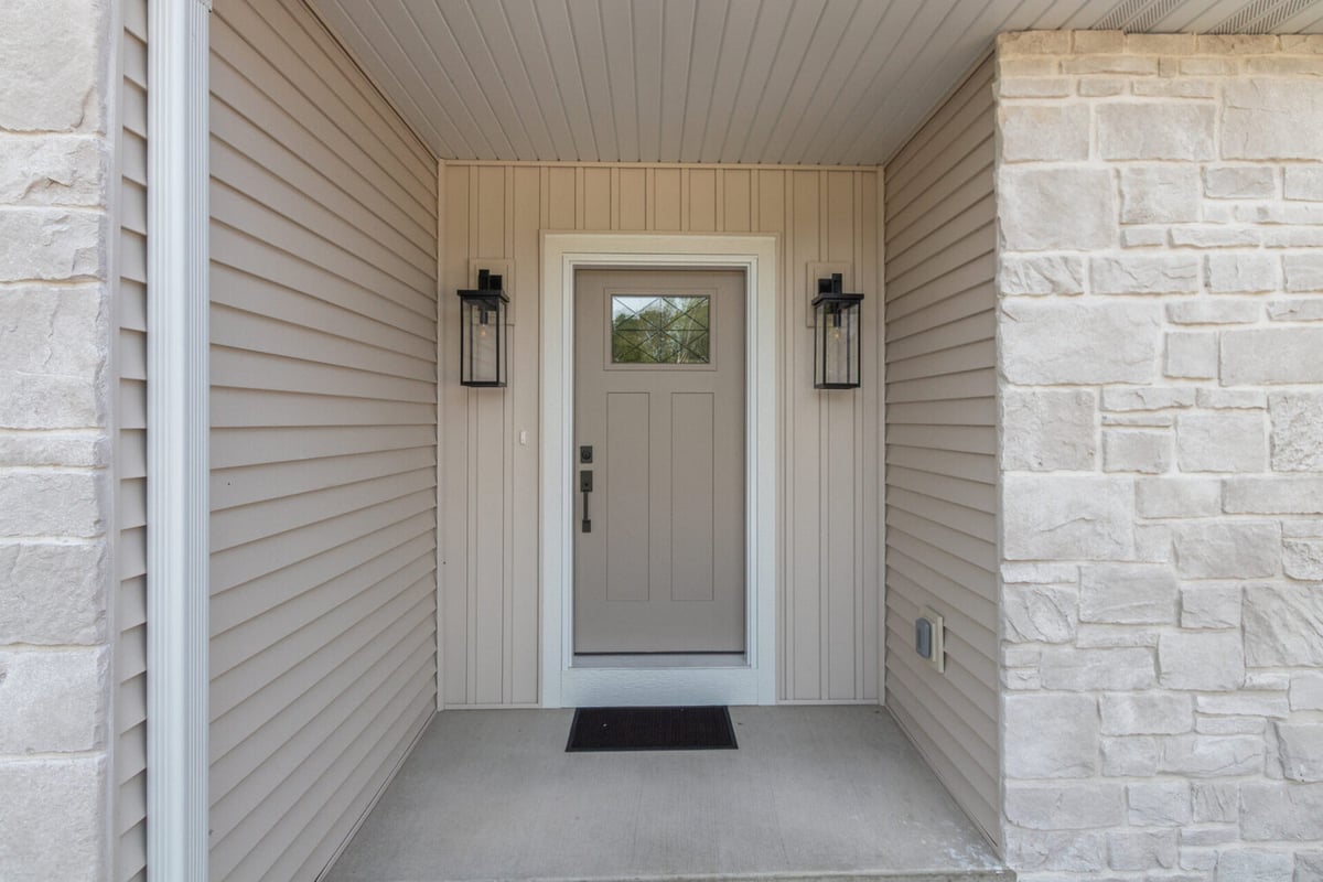 Covered front entry with modern door on a custom home by Midwest Design Homes in Kaukauna, WI