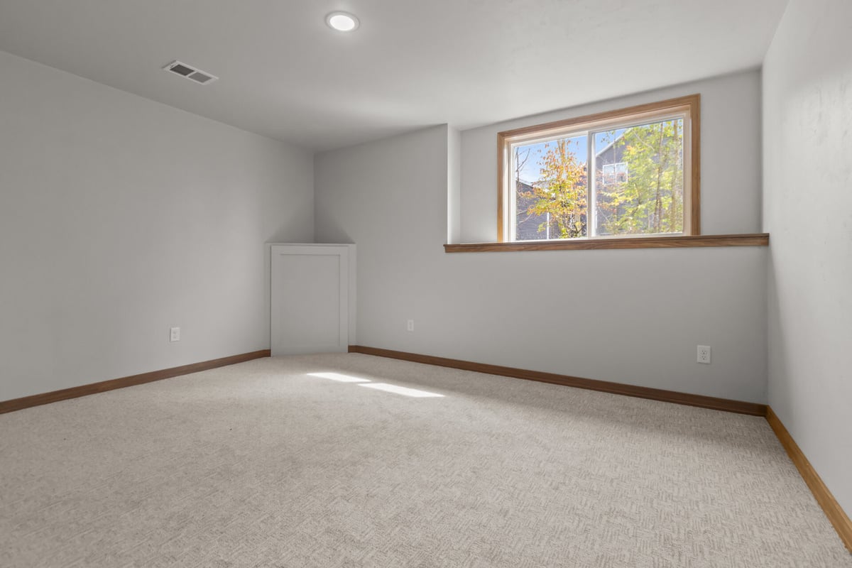 Custom basement room with natural light and white doors by Midwest Design Homes in Ledgeview, WI