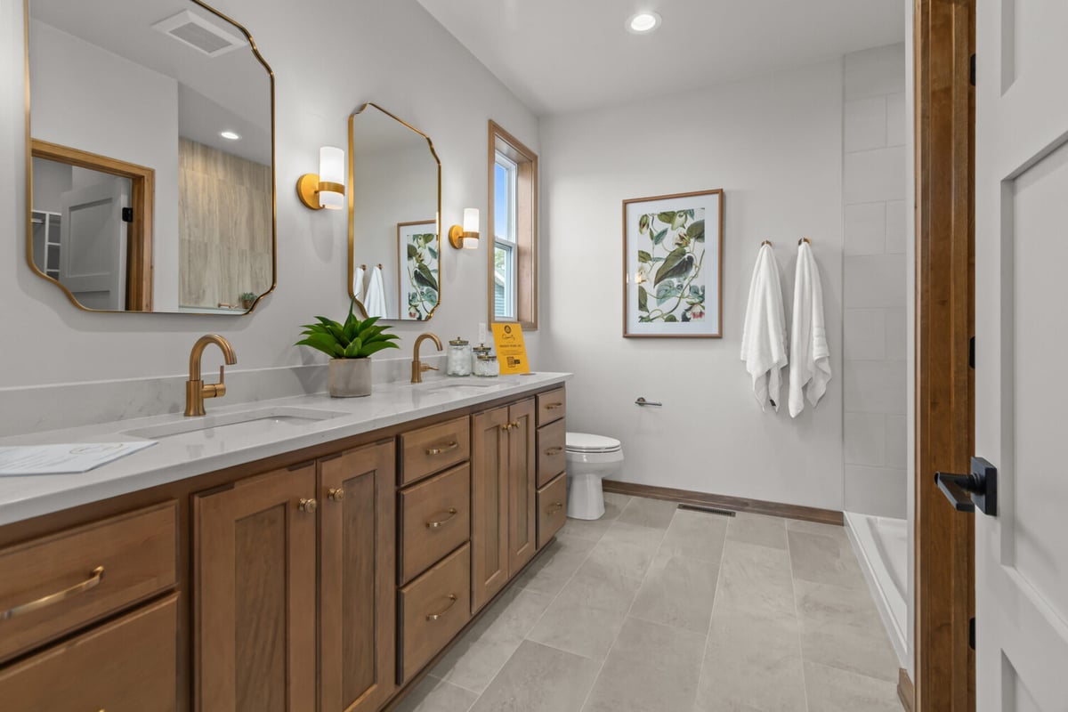Custom bathroom featuring wood cabinetry and quartz countertops by Midwest Design Homes in Fox Cities, WI