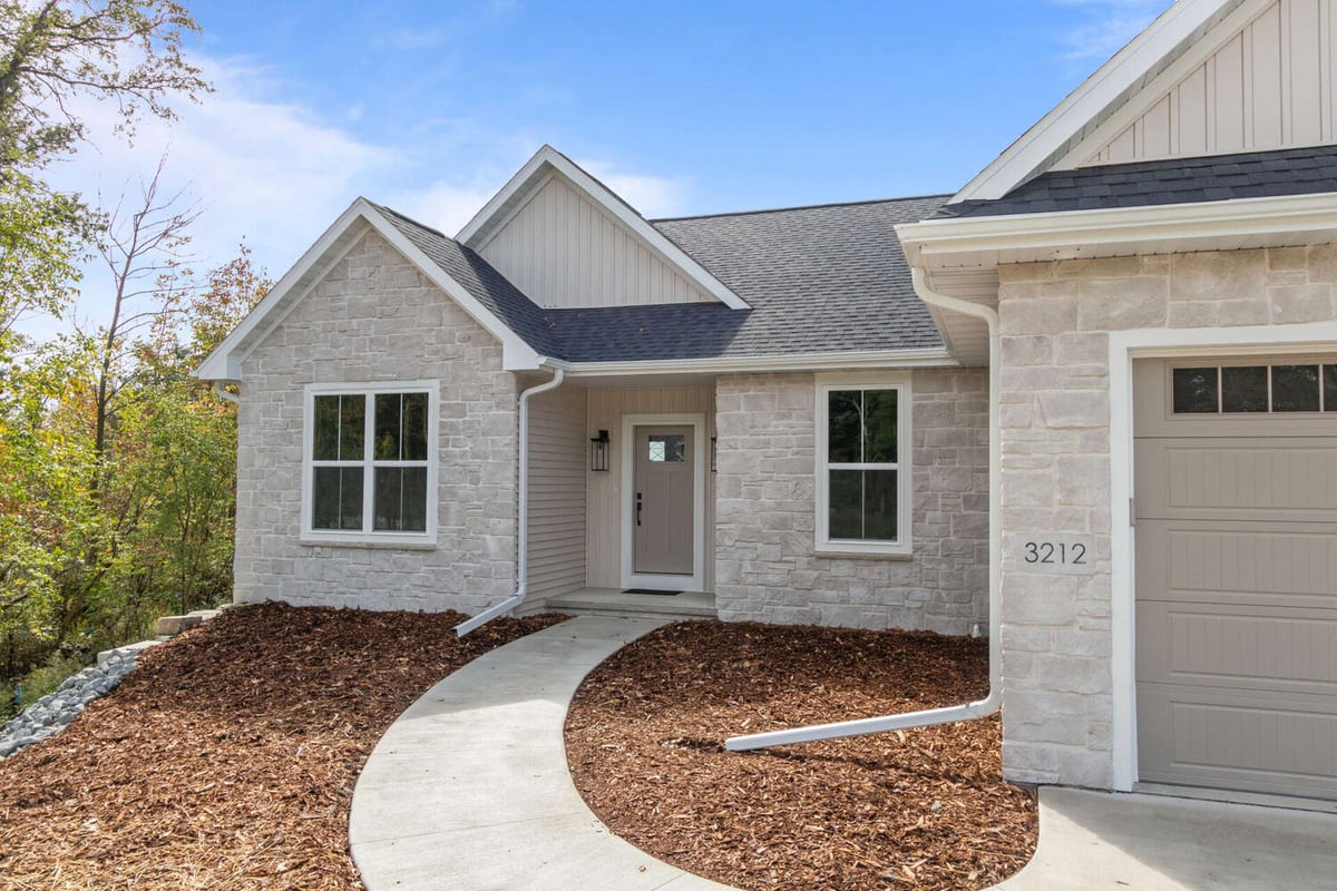 Front exterior of custom stone home by Midwest Design Homes in the Fox Cities, WI