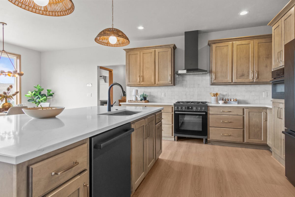 Kitchen island with black sink fixtures in a custom home by Midwest Design Homes in Bellevue, WI