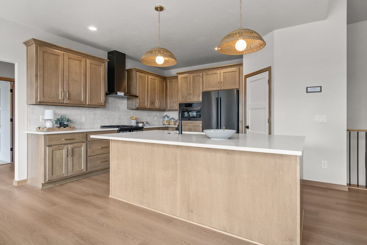 Kitchen island with pendant lighting in a custom home by Midwest Design Homes in Green Bay, WI