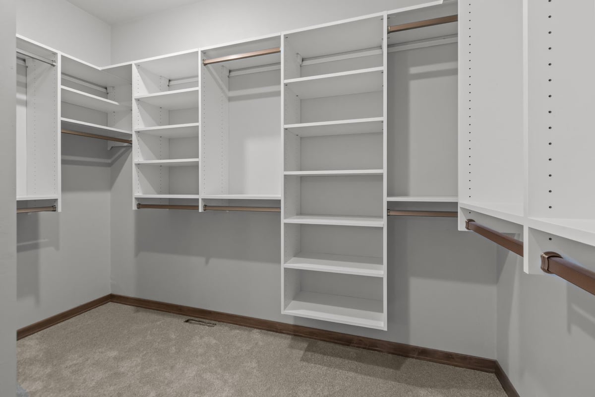 Spacious walk-in closet with built-in shelving in a custom home by Midwest Design Homes in Lawrence, WI
