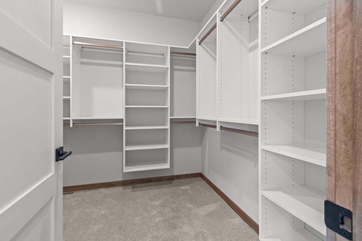 Walk-in closet with built-in storage solutions in a custom home by Midwest Design Homes in Fremont, WI