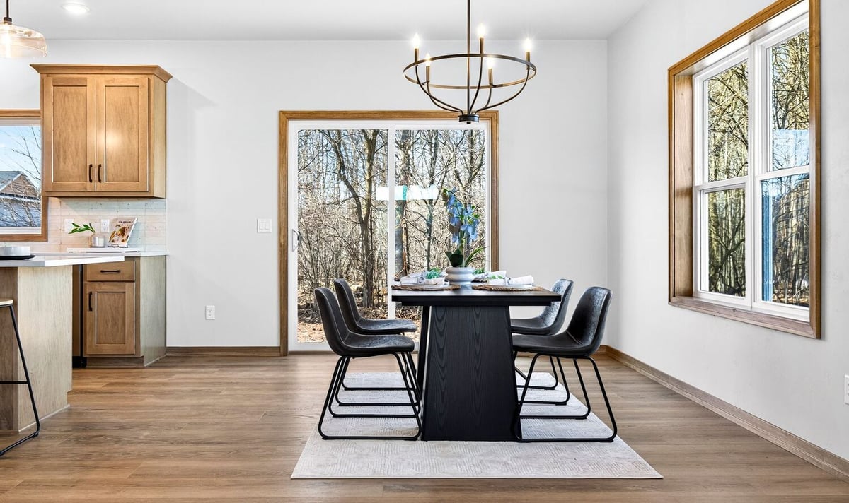 Dining space with sliding glass doors, natural light, and modern fixtures in a Fox Cities home