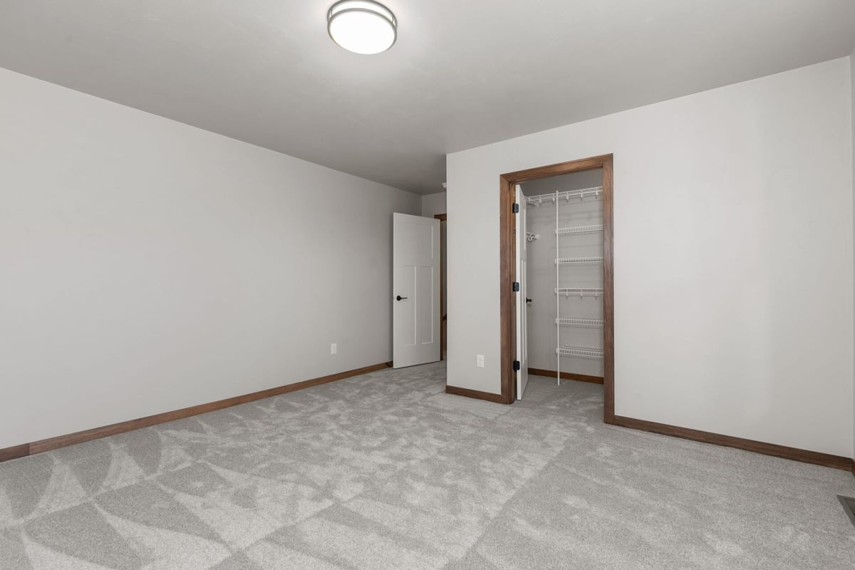 Bedroom interior with closet and trim accents in a Fox Cities, WI custom home by Midwest Design Homes