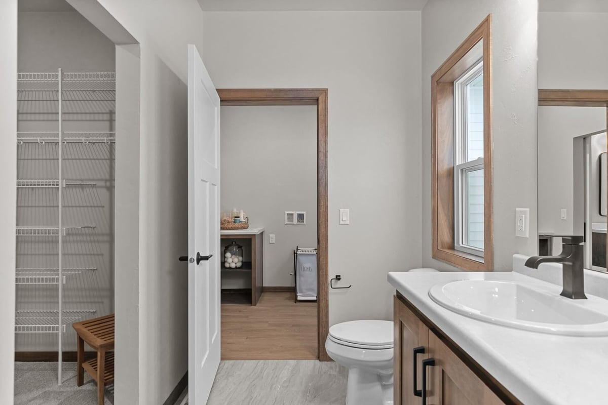 Custom bathroom with entry to closet and laundry in a Neenah, WI home by Midwest Design Homes