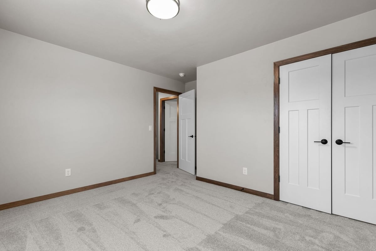 Custom home bedroom with double closet doors by Midwest Design Homes in Greenville, WI