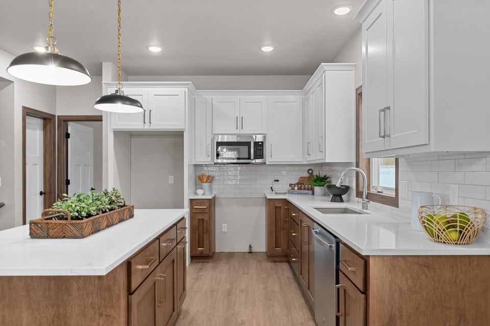 Custom kitchen with white cabinetry and stainless appliances by Midwest Design Homes in Neenah, WI