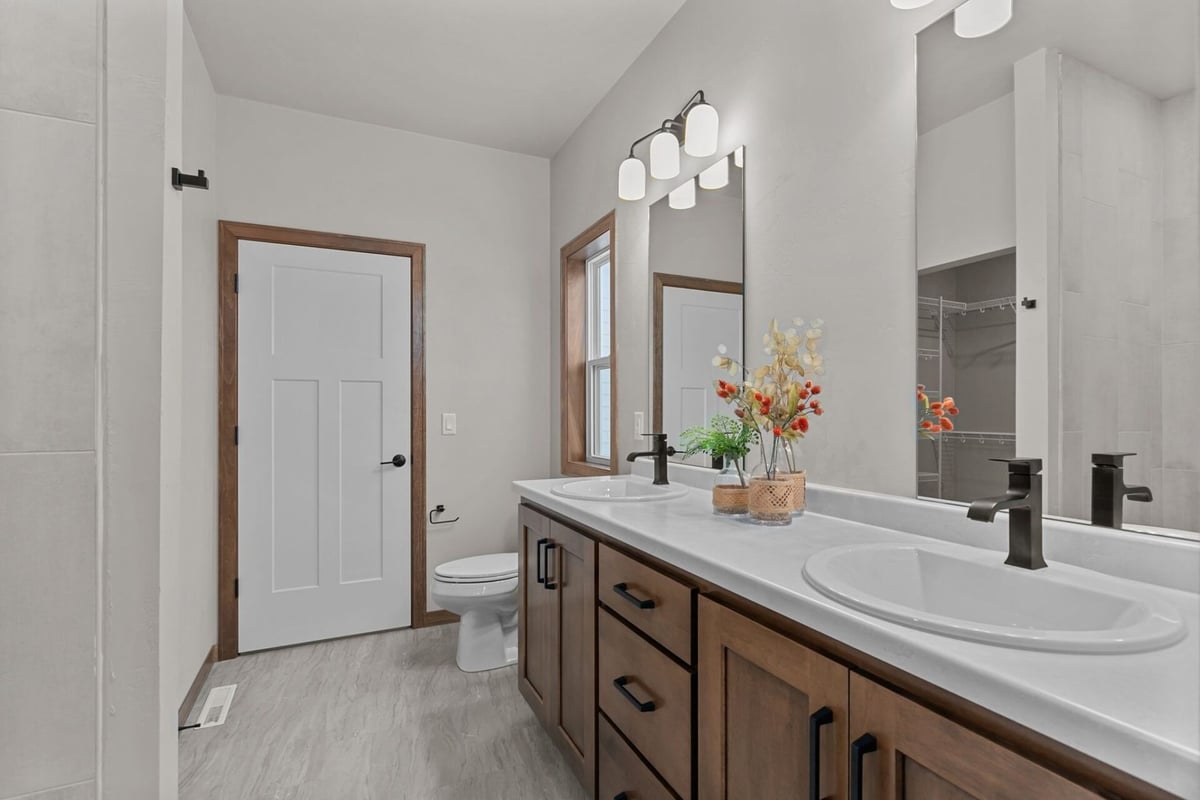 Dual-sink vanity in primary bathroom of a custom home by Midwest Design Homes in Fox Cities, WI