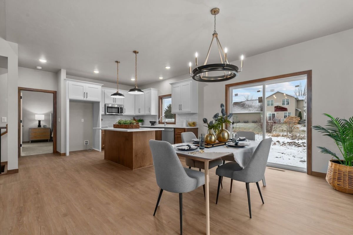 Kitchen and dining space with island and pendant lighting in a Fox Cities, WI custom home by Midwest Design Homes