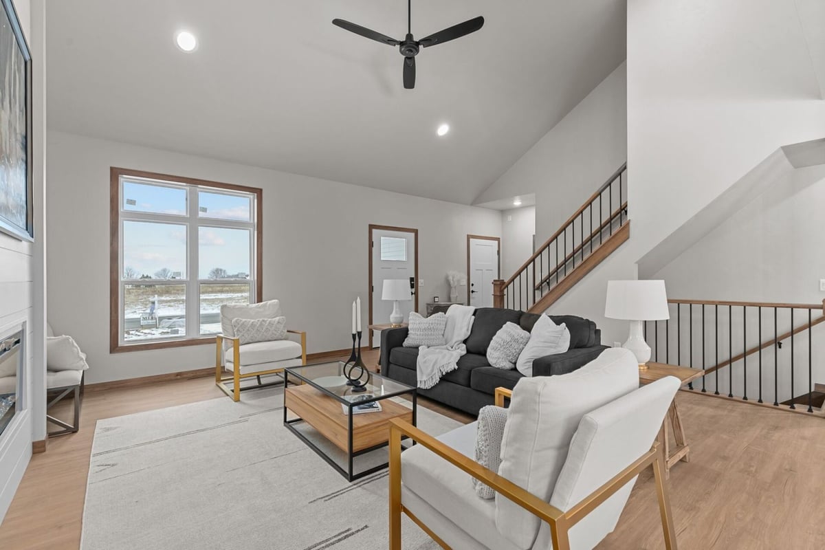 Living room with vaulted ceiling and modern furnishings by Midwest Design Homes in Harrison, WI