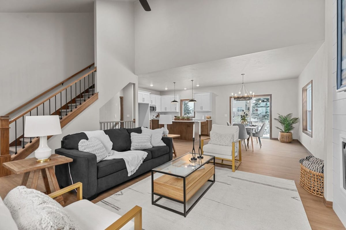 Open living and dining room connected to kitchen by Midwest Design Homes in Ellington, WI