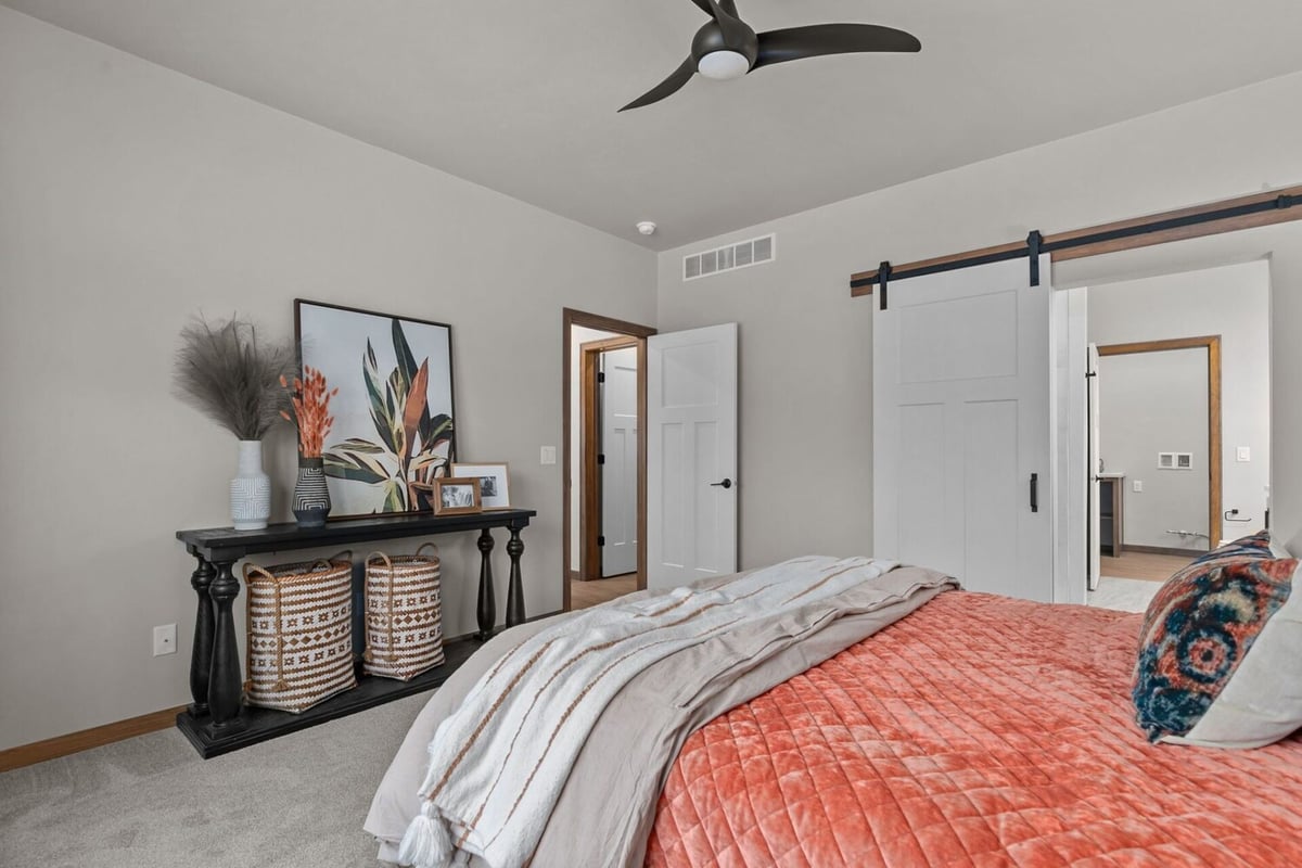 Stylish master bedroom with modern farmhouse elements in a Wisconsin custom home by Midwest Design Homes
