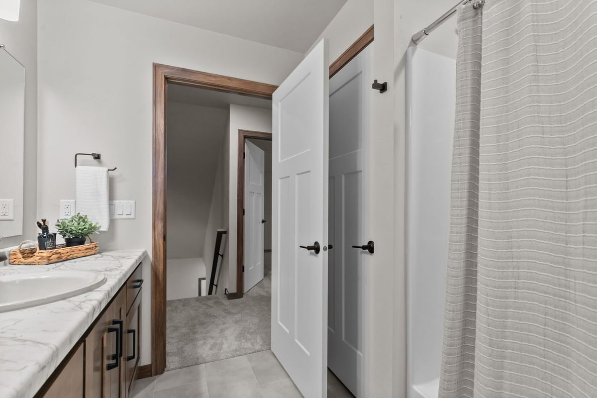 Transitional space from bathroom to hallway in a custom home by Midwest Design Homes in Neenah, WI