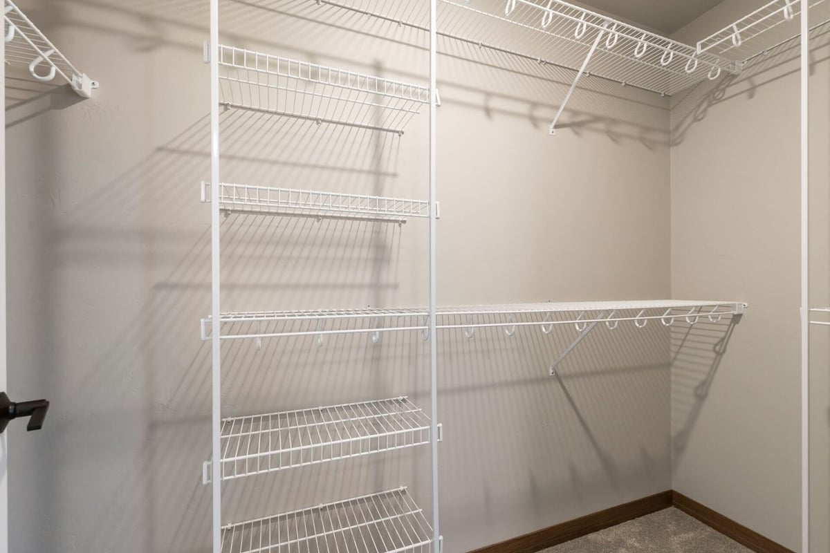 Walk-in closet with white wire shelving by Midwest Design Homes in Green Bay, WI