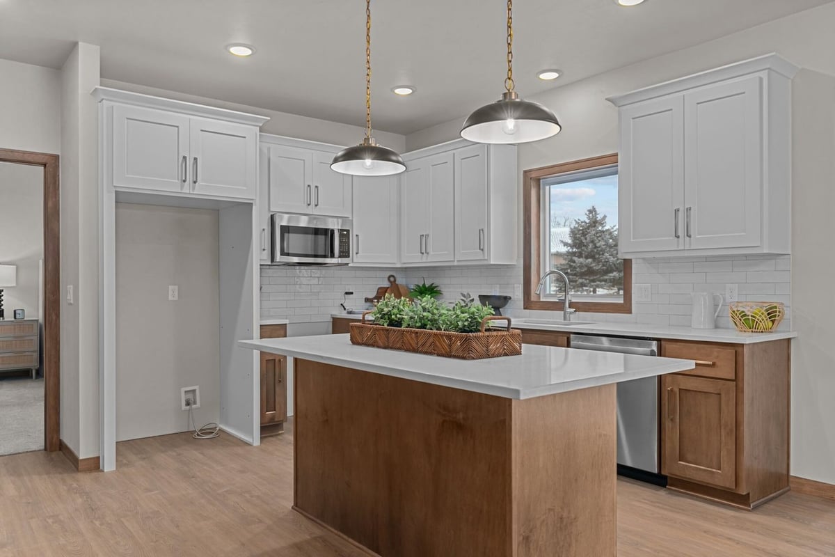 White and wood custom kitchen with island by Midwest Design Homes in Green Bay, WI